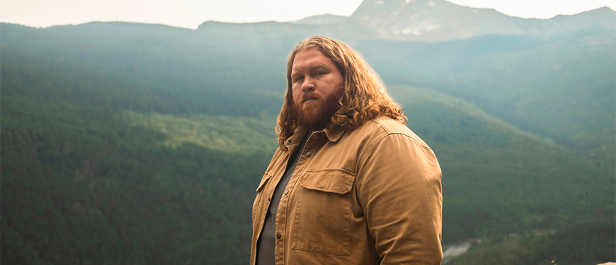 Michael Cochren of Cochren & Co. standing outdoors with a mountainous forest background